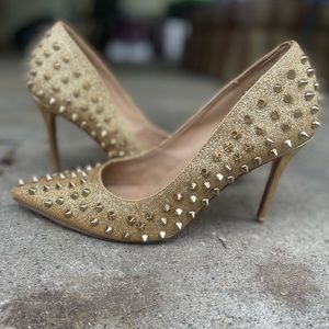 Christian Louboutins glittery gold spiked pumps